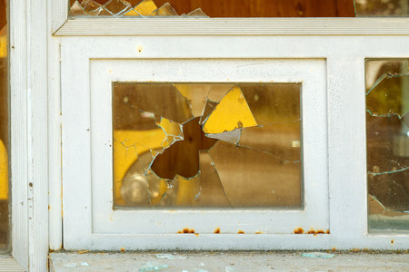 Broken glass windows on old abandoned urban kiosk, selective focusの写真素材