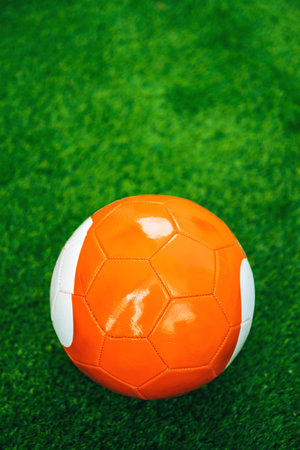 Orange soccer ball on artificial grass pitch, selective focusの写真素材