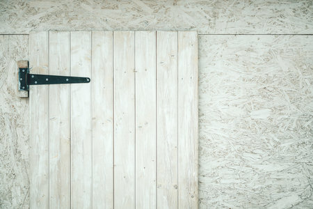 Wooden window with closed shutters on white shed as backgroundの写真素材