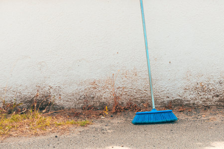Blue cleaning broom against old wall as copy spaceの写真素材