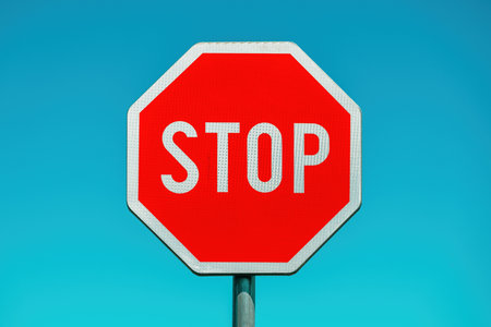 Stop, traffic sign against blue sky, selective focus