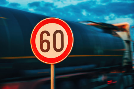 Cistern truck speeding by the speed limit traffic sign, motion blur image with selective focusの写真素材