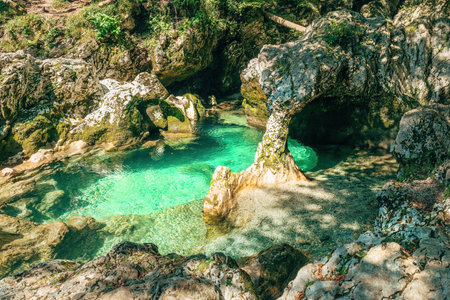 Whimsical rock shaped like an elephant above emerald waters in Sloveniaâs Mostnica Gorge.. Selective focus.の写真素材