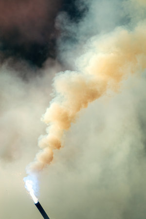 Bengal torch burning with dense smoke outdoors, flare torch emitting heavy smoke cloud. Selective...
