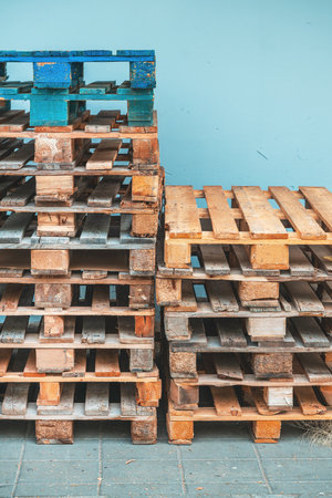 Pile of weathered euro pallets showing signs of wear and age. Selective focus.