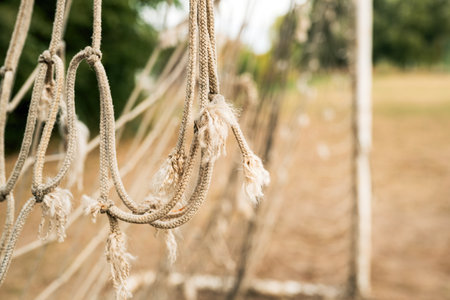 Damaged soccer goal net, symbolizing decay, time, and the passage of many games. Selective focus.の写真素材