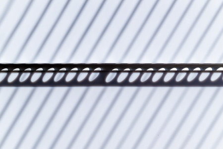 Minimalist shadow of blinds with elliptical light spots, as abstract background and textureの写真素材