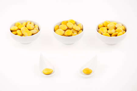 Lupins beans snacks appetizer in three small cups and two spoon on white background.の写真素材