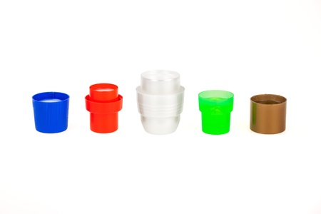 Five full plastic colorful detergent and soap caps isolated on white background. 