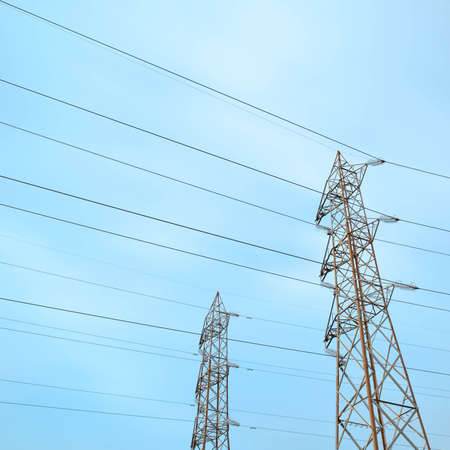 Two transmission towers, also known as electricity pylons with parallel wires.の写真素材