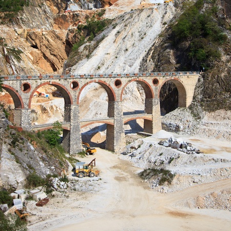 White marble quarry old bridge and excavators at work  Apuan Alps, Carrara, Tuscany, Italy, Europeの写真素材