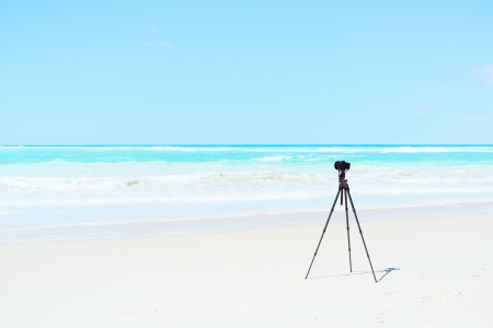 Digital Camera, tripod and filters on white beach ready for landscape photographyの写真素材