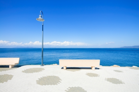 Bench and lamp on the sea in Porto Santo Stefano travel destination  Argentario, Tuscany, Italy の写真素材
