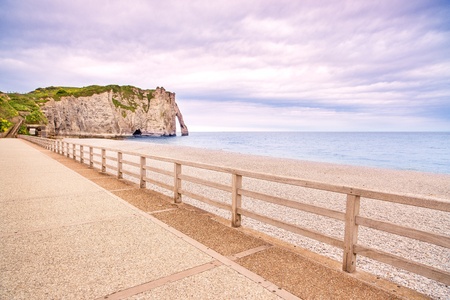 Etretat Aval cliff landmark, balcony and beach under a cloudy sky  Normandy, France, Europe の写真素材