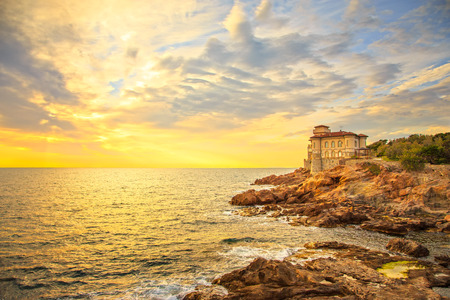 Boccale castle landmark on cliff rock and sea on warm sunset. Tuscany, Italy, Europe.のeditorial素材