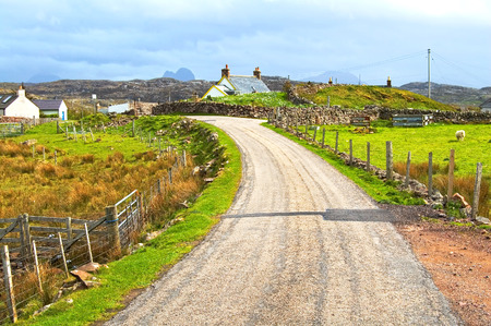 Highlands of Scotland narrow road in rural landscape. Uk, Europe.の写真素材