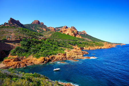 Esterel mediterranean red rocks coast, beach and sea. French Riviera in Cote d Azur near Cannes Saint Raphael, Provence, France, Europe. Esterel mediterranean red rocks coast, beach and sea. French Riviera in Cote d Azur near Cannes Saint Raphael, Provence, France, Europe.