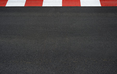 Texture of motor race asphalt and red white curb on Grand Prix street circuitの写真素材