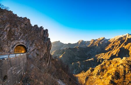 Alpi Apuane mountain road pass and tunnel view at sunset. Movie location in Carrara, Tuscany, Italy. Europe.の写真素材