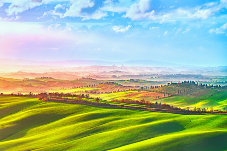 Siena city panoramic skyline, countryside and rolling hills in a misty day. Tuscany, Italy, Europe.の写真素材