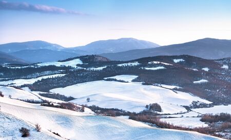 Snow in Tuscany, winter panorama at sunset. Montecastelli, Siena, Italy Europe.の写真素材