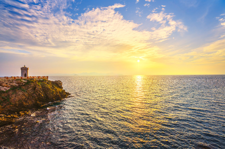 Sunset view of Piombino piazza bovio lighthouse and Elba Island. Maremma Tuscany Italy