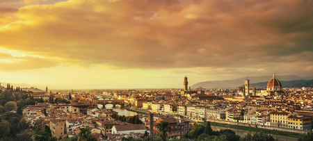 Florence or Firenze sunset aerial cityscape. Panorama view from Michelangelo park square. Ponte Vecchio bridge, Palazzo Vecchio and Duomo Cathedral. Tuscany, Italyの写真素材