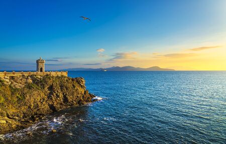 Sunset view of Piombino piazza bovio lighthouse and Elba Island. Maremma Tuscany Italy