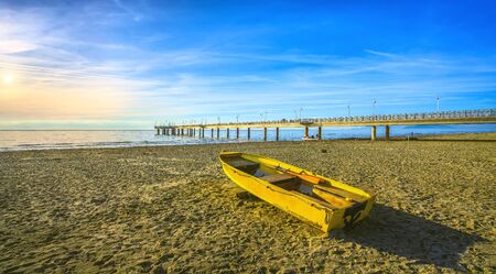 Pier or jetty, boat on the beach and sea in Marina di Pietrasanta. Versilia Lucca Tuscany Italyの写真素材