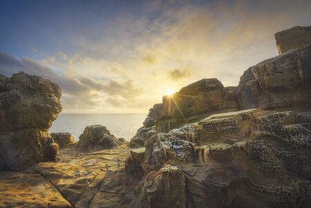 Rocks eroded by the wind and sea in Populonia cliff Buca delle Fate at sunset. Piombino, Maremma Tuscany, Italy.の写真素材