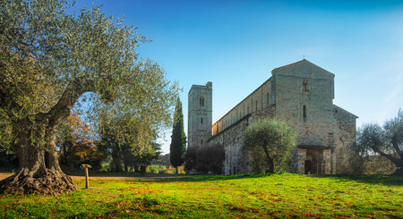 Sant Antimo abbey in the morning, olive and cypress trees. Montalcino. Tuscany, Italyのeditorial素材