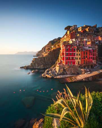 Riomaggiore town, cape and sea at sunset. Seascape in Cinque Terre National Park, Liguria, Italy, Europe. Long Exposure Photographyの素材 [FY310181141702]