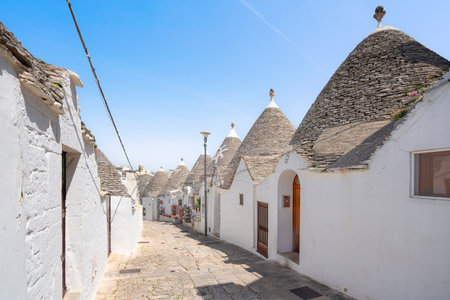 Trulli traditional Apulian dry stone hut with conical roof. Street view in Alberobello town. Puglia or Apulia region, Italyの写真素材