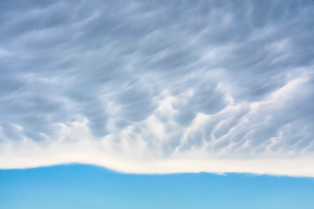 Mammatus clouds over a clear sky in horizontal format. End of the storm