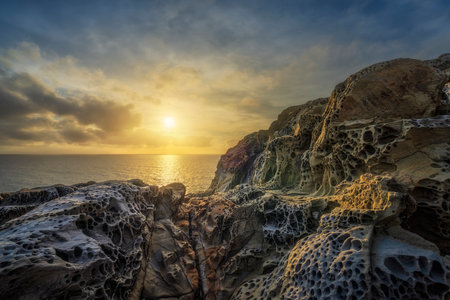 Sea at sunset and rocks eroded by the wind in Populonia cliff Buca delle Fate. Seascape in Maremma....