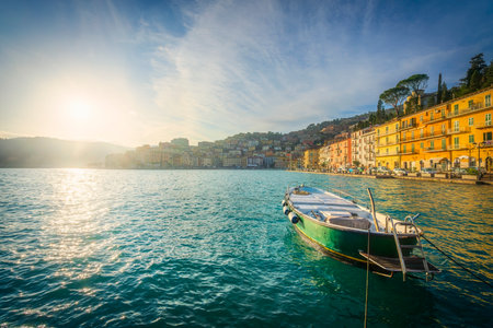 Wooden small boat in Porto Santo Stefano seafront at sunrise. Italian travel destination. Monte Argentario, province of Grosseto, Tuscany region, Italy.の写真素材