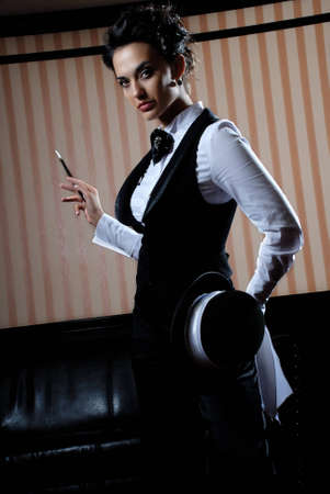 Woman on the striped background wearing business clothes, smoking.の写真素材
