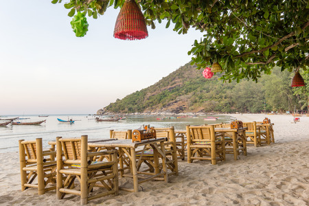 Ao Thong Nai Pan Yai, Koh Pangan, Thailand, April 22, 2016, Tables  on a beautiful beach. In the trees hang some  lanterns.の写真素材