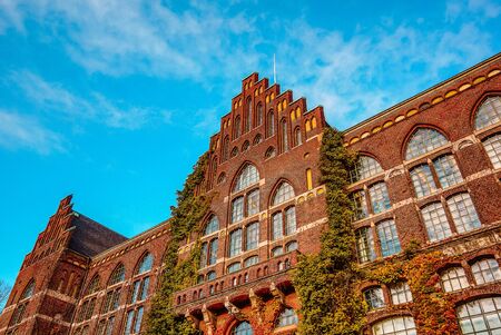 Lund University Library. An huge  brick facade with ivy against blue sky, Sweden, Nov 8, 2016,のeditorial素材