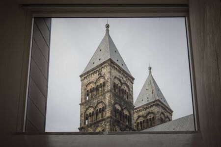 The towers of Lund cathedral seen through a window in the Cathedral Forum, Lund, Sweden, Mars 14,...