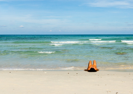 Woman resting on a white beach among the waves, Koh Phangan, Thiland - May 5, 2016のeditorial素材