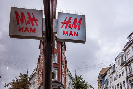 HM man sign reflections in a store window, against blue sky, Copenhagen, Denmark, September 21, 2017のeditorial素材