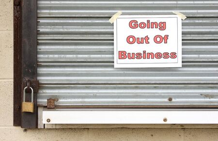 Closed locked steel door of a business that has gone bankruptの写真素材