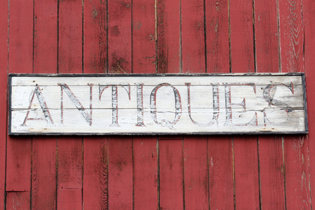 Antiques Sign on the side of an old red barnの写真素材