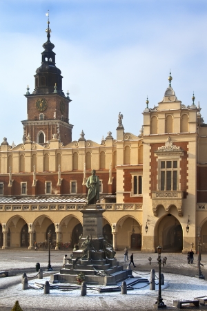 The Cloth Hall - Sukiennice - and Town Hall Tower in the main market square (Rynek Glowny) in Cracow in Poland. The statue is of Adam Mickiewicz.  The Cloth Hall dates from 1895.のeditorial素材