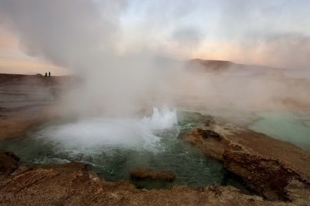 El Tatio geyser field is located within the Andes Mountains of northern Chile at 4,200 meters above mean sea level  The best time to see them is at sunrise when each geyser is surmounted by a column of steam that condenses in the bitterly cold morning airのeditorial素材