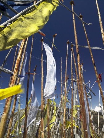 Buddhist prayer flags on a hillside high in the Himalayas in the Kingdom of Bhutan の写真素材