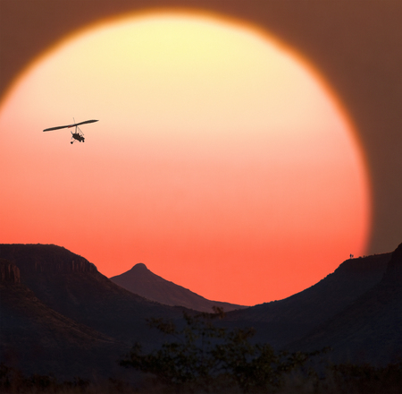 Microlight aircraft and a Namibian Sunset - Damaraland in northern Namibiaの写真素材