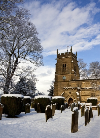 Winter snow in a church graveyard in the small village of Slingsby in North Yorkshire in the northeast of England の写真素材
