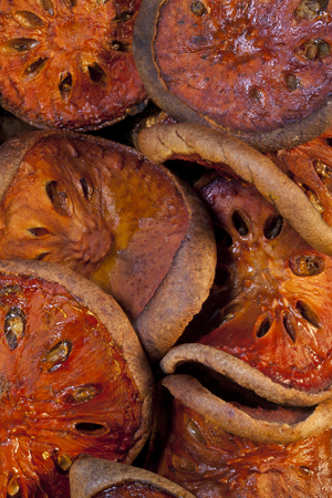 Bael Fruit - The fruit is dried  it is usually sliced and sun-dried   The hard leathery slices are then simmered in water often with a slice of lime or a dash of lime juice to make a fruit tea の写真素材